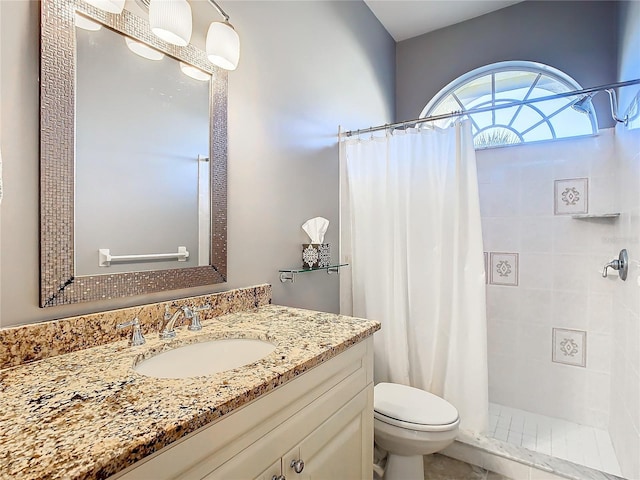 bathroom featuring curtained shower, vanity, and toilet