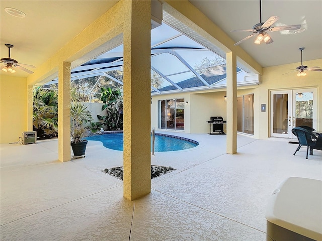 view of pool with a lanai, a patio area, a grill, and french doors