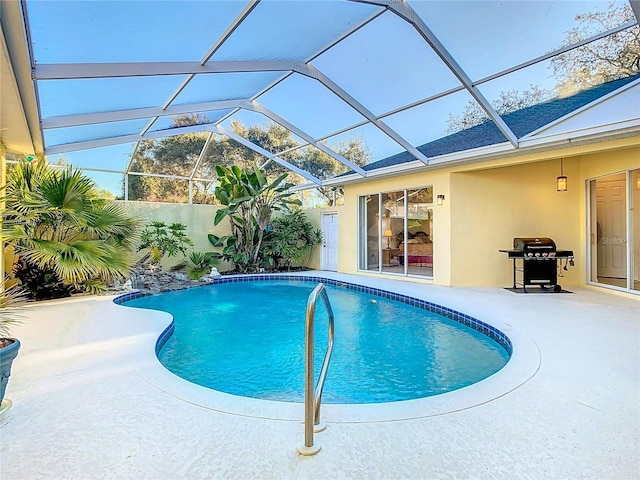 view of pool with a fenced in pool, area for grilling, a lanai, and a patio area