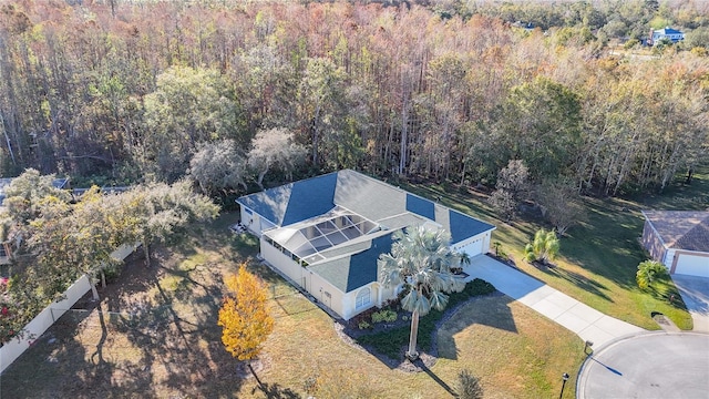 drone / aerial view featuring a wooded view