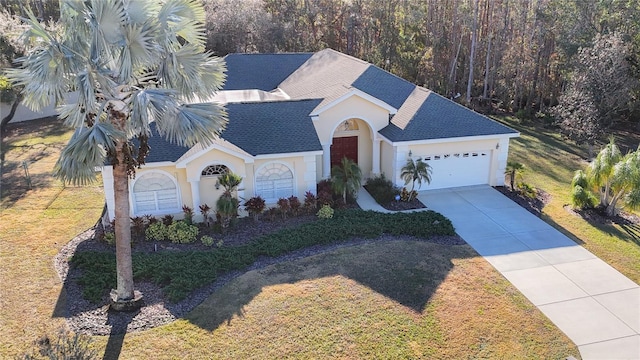 view of front facade featuring a front lawn and a garage