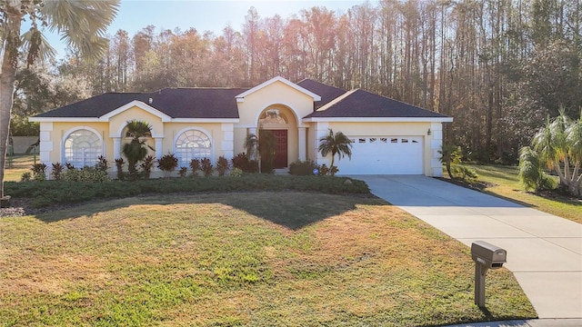 view of front of home with a garage and a front yard