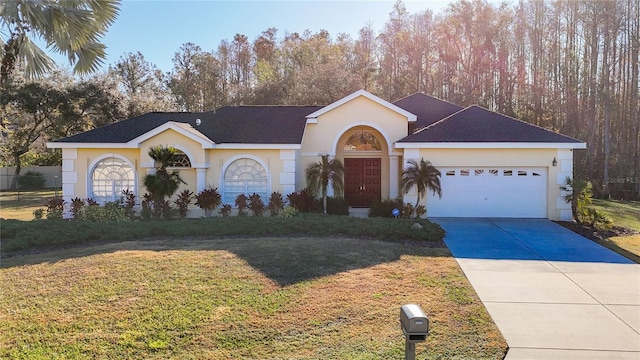 ranch-style house featuring a front lawn, a garage, driveway, and stucco siding