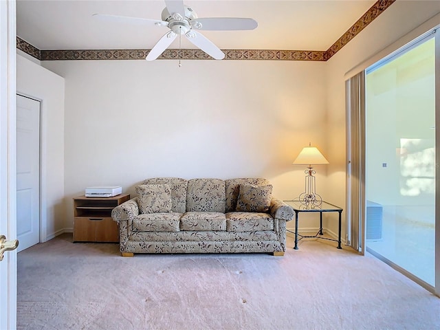 carpeted living room with a ceiling fan and baseboards