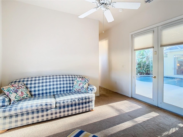 living room featuring carpet flooring, ceiling fan, and french doors