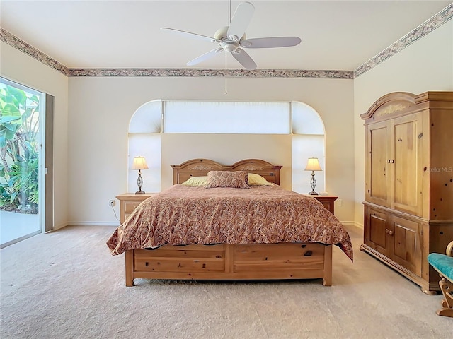 bedroom with access to exterior, light colored carpet, a ceiling fan, and baseboards