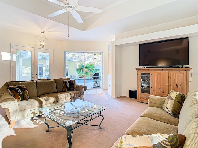 living area with ceiling fan, baseboards, lofted ceiling, light carpet, and french doors