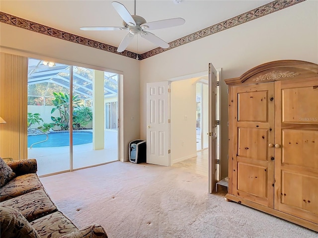 interior space featuring light carpet, baseboards, and ceiling fan