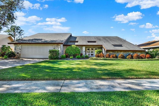 view of front of house featuring a front yard and a garage