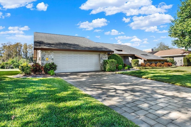 view of front facade with a garage and a front lawn