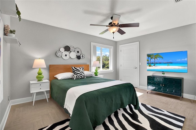 bedroom with ceiling fan and light parquet flooring