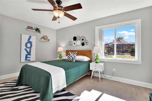 bedroom with ceiling fan and parquet floors