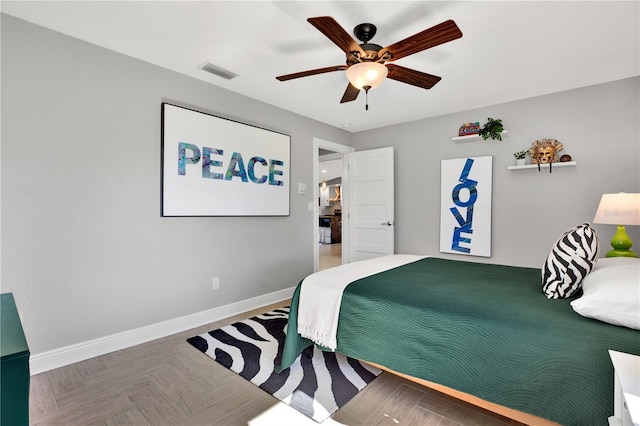 bedroom featuring ceiling fan and parquet floors