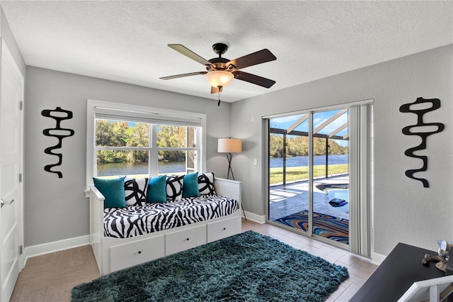 sitting room with ceiling fan and a healthy amount of sunlight