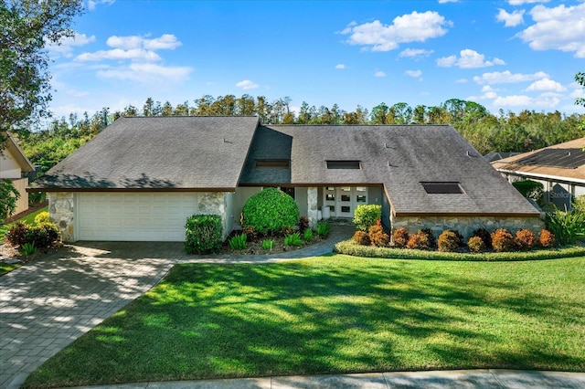 view of front of property featuring a garage and a front yard