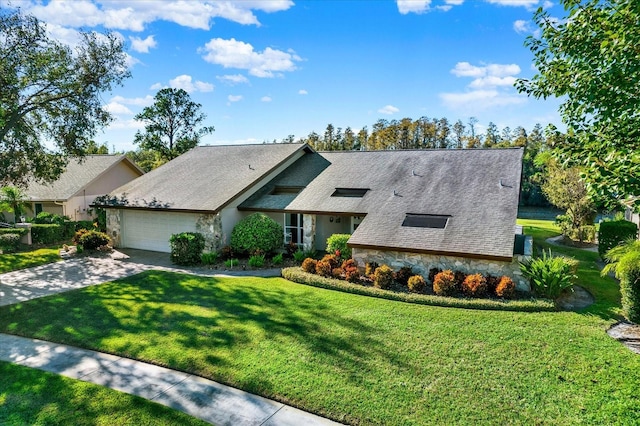 view of front of home with a front yard and a garage