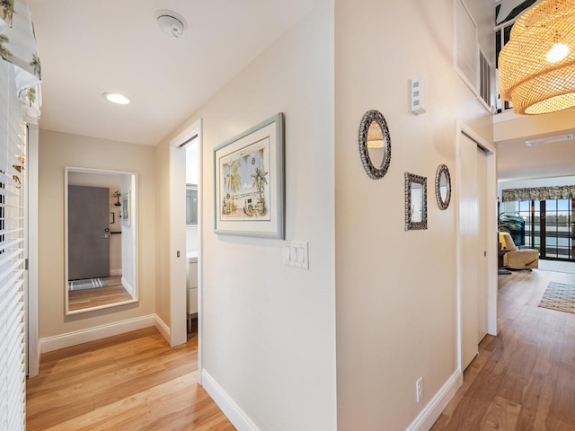 corridor with light hardwood / wood-style floors