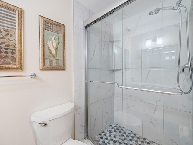 bathroom with toilet and an enclosed shower