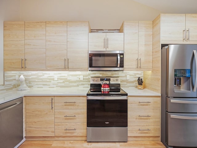 kitchen featuring light brown cabinets, backsplash, and stainless steel appliances