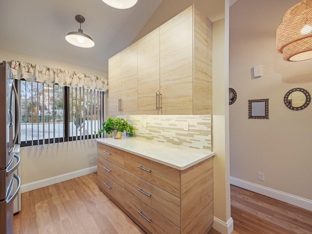 interior space with light hardwood / wood-style floors and vaulted ceiling