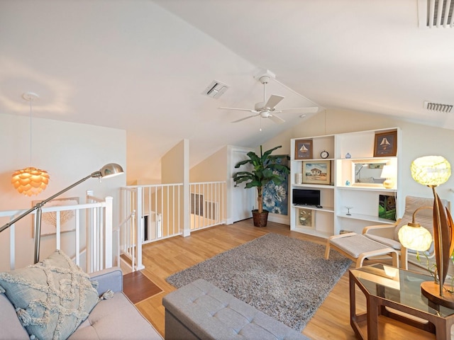 living room with hardwood / wood-style flooring, vaulted ceiling, and ceiling fan