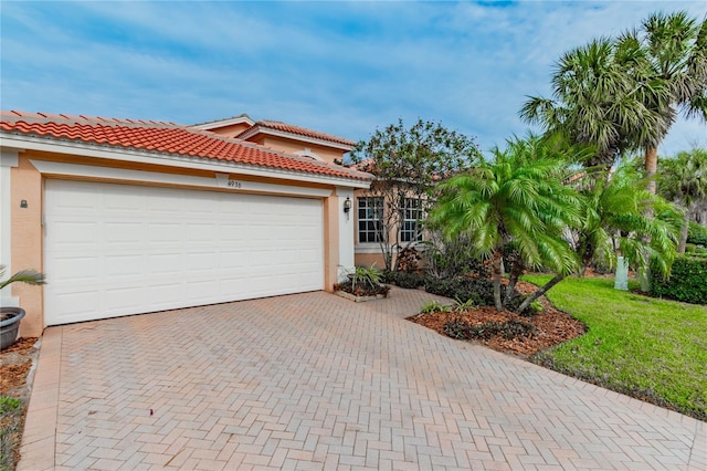 mediterranean / spanish-style home with a garage