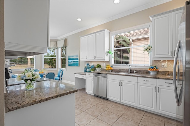 kitchen featuring stainless steel appliances, white cabinetry, ornamental molding, and sink