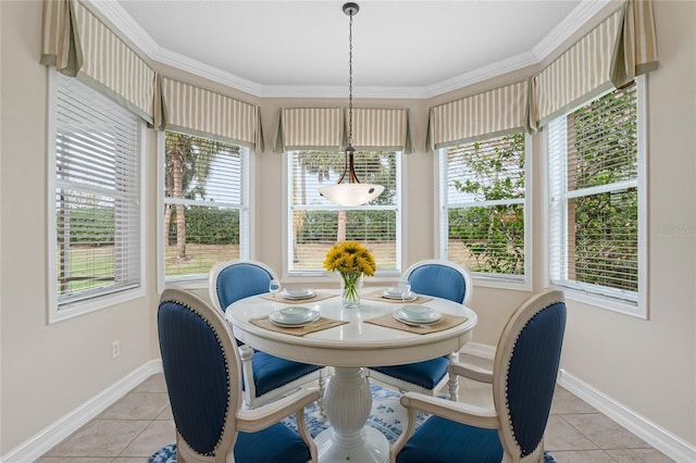 dining room with a wealth of natural light, crown molding, and light tile patterned flooring