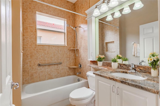 full bathroom featuring toilet, vanity, and tiled shower / bath