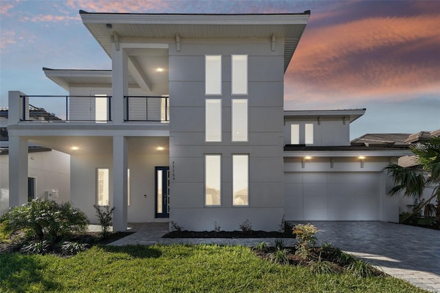 contemporary home featuring a balcony and a garage