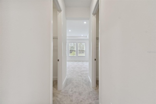 hall with light colored carpet