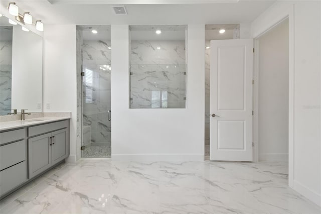 bathroom with a shower with door and vanity