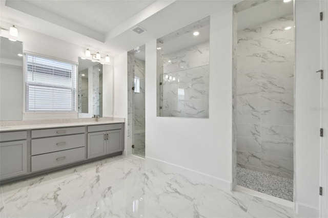 bathroom with vanity and tiled shower