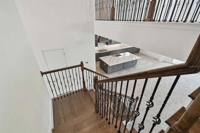 stairs featuring hardwood / wood-style floors