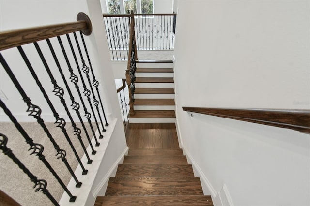 stairway with hardwood / wood-style flooring