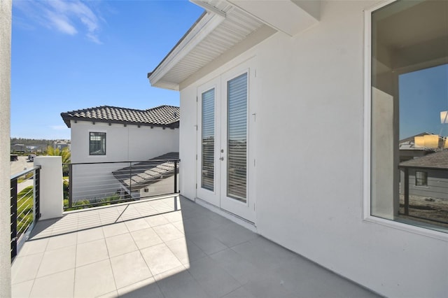 view of patio with french doors and a balcony