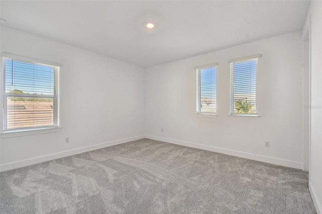 unfurnished room with light colored carpet