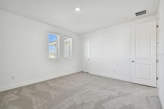 unfurnished room with light colored carpet