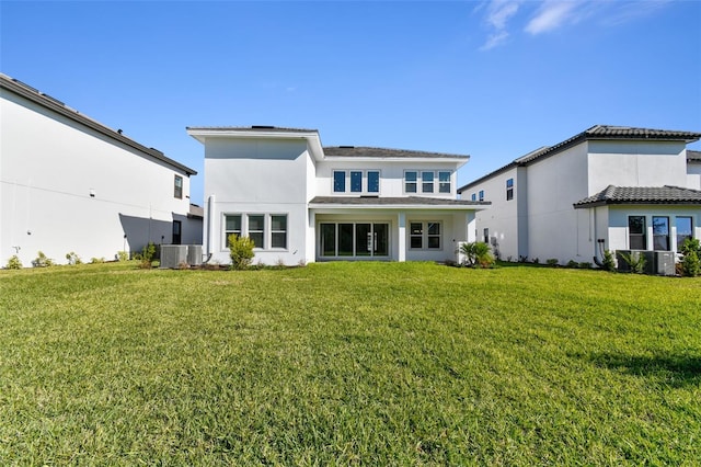 rear view of property with a yard and cooling unit