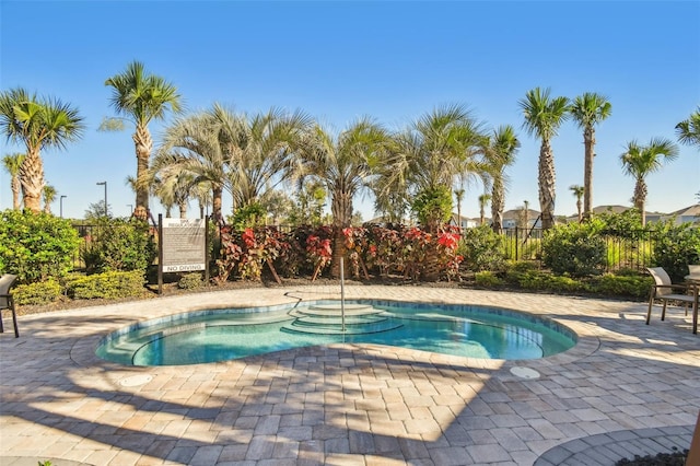 view of pool with a community hot tub and a patio area