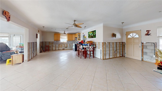 tiled foyer with ceiling fan