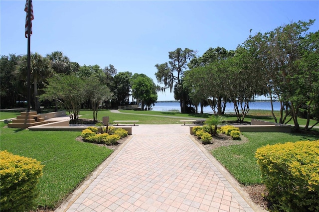 view of property's community featuring a water view and a yard