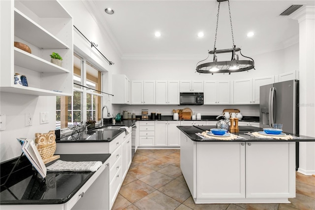 kitchen featuring a center island, sink, ornamental molding, white cabinetry, and stainless steel appliances