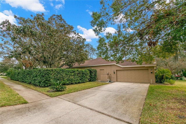 view of front of home featuring a garage and a front lawn