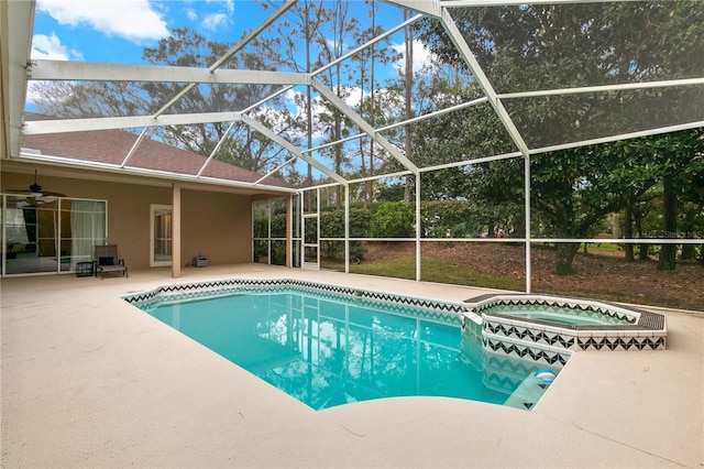 view of pool with a lanai, a patio area, ceiling fan, and an in ground hot tub