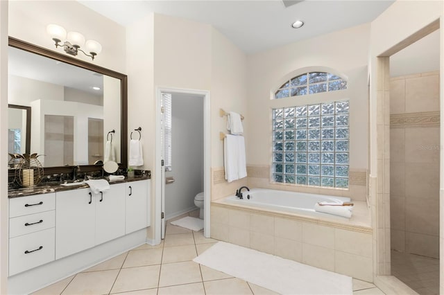 full bathroom with tile patterned flooring, vanity, separate shower and tub, and toilet