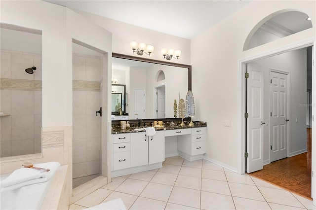 bathroom with tile patterned floors, vanity, and independent shower and bath