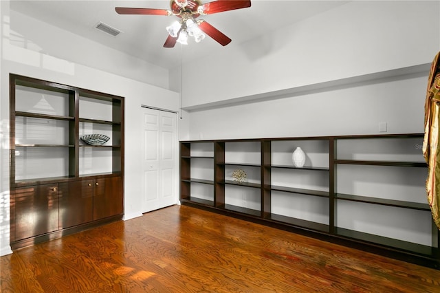 spare room featuring ceiling fan and dark wood-type flooring