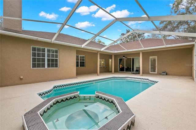 view of swimming pool with an in ground hot tub, a patio area, and a lanai