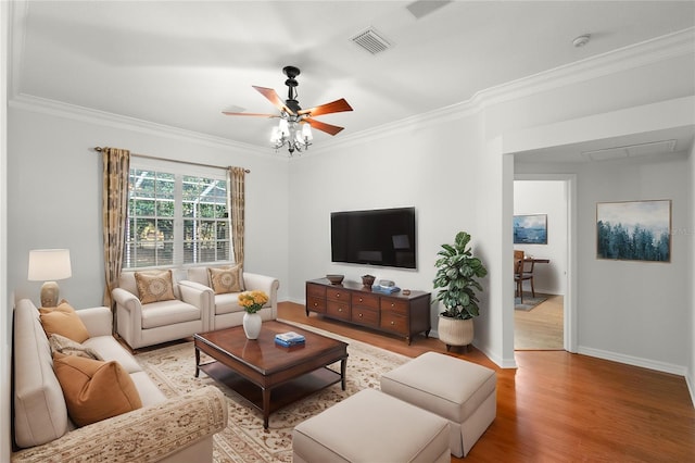 living room featuring ceiling fan, ornamental molding, and light hardwood / wood-style flooring